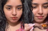 woman apply chilli flakes on lips