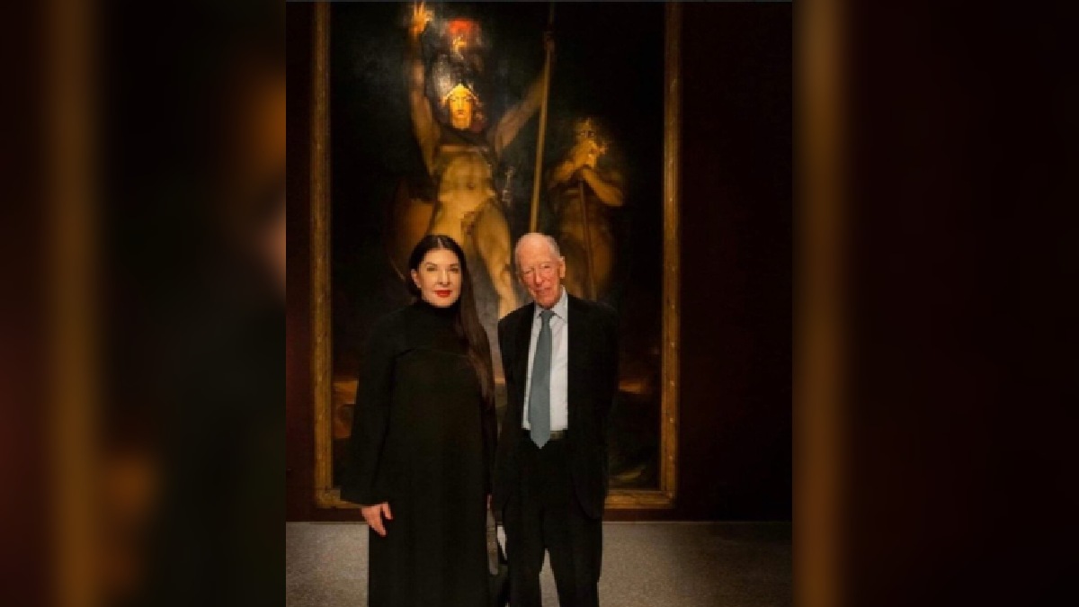 Marina Abramovic posing with Lord Jacob Rothschild in front of one of her paintings that goes by the name of Satan summoning his Legions (1979) by Sir thomas Lawrence.